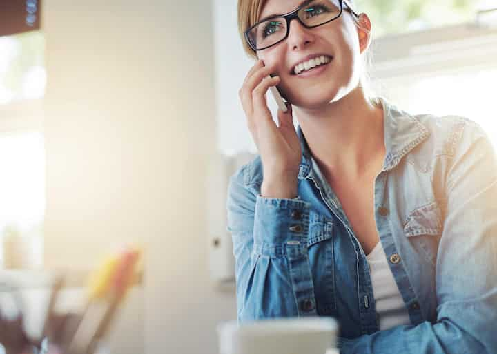 A nice lady calling a local expert for water damage repair in her home.